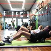 Volleyball athletes completing core strength and conditioning exercises during sports performance training at BAM BAM Training