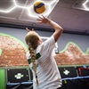 High school volleyball athlete practicing an overhead serve during performance training at BAM BAM Training