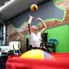 Youth volleyball player practicing ball control and reaction drills during BAM BAM Training summer volleyball camp